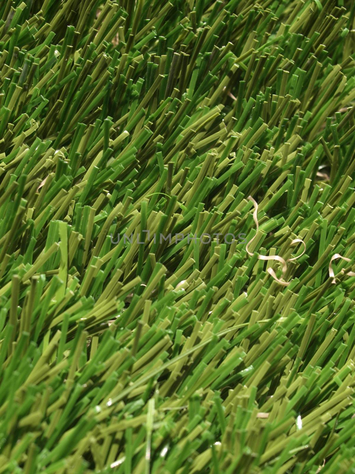 Detail of green grass artificial lawn meadow, useful as a background