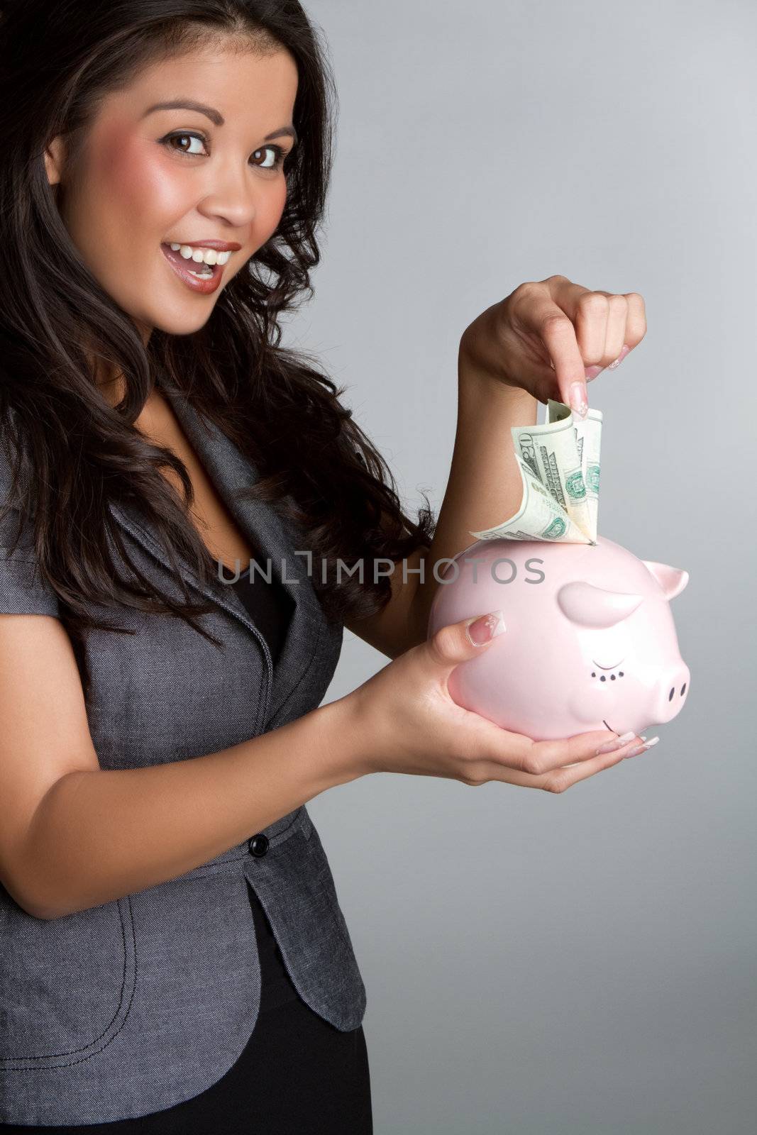 Business woman holding piggy bank