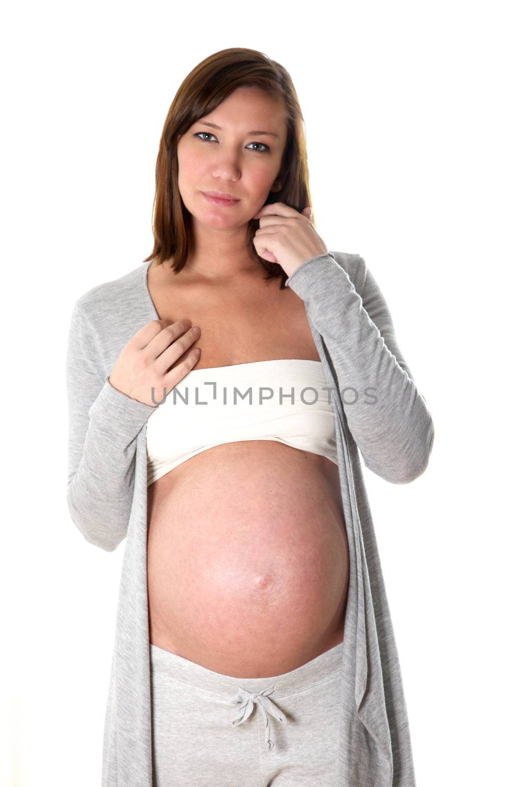 standing pregnant woman looks thoughtfully at camera rond
