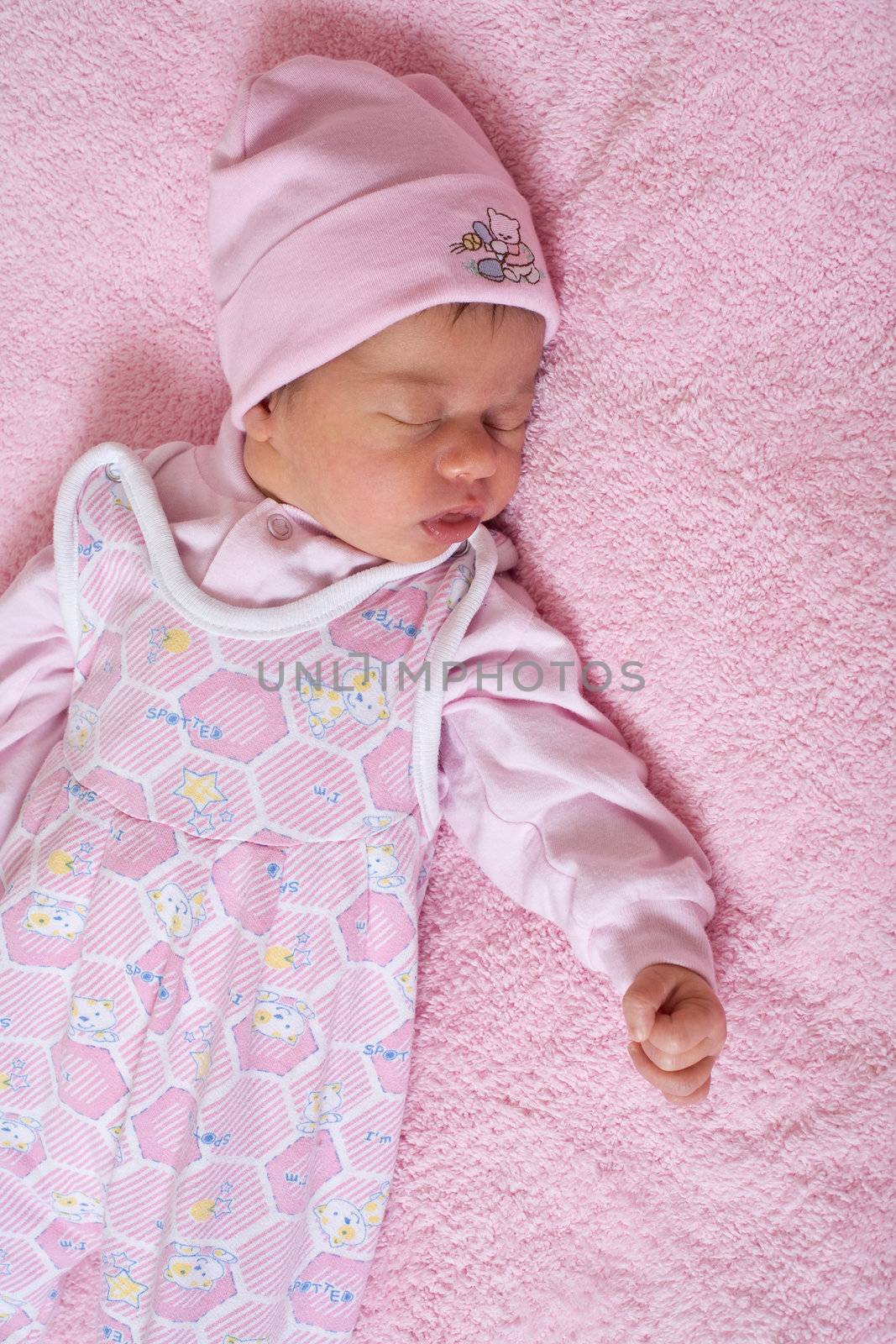 children series: slepping newborn baby in pink color