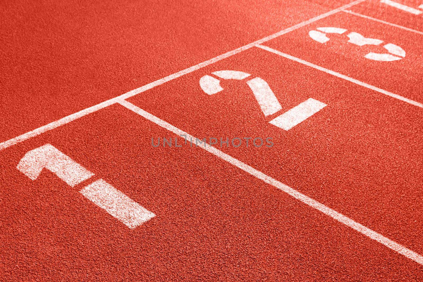 Close up of numbers on red running track.