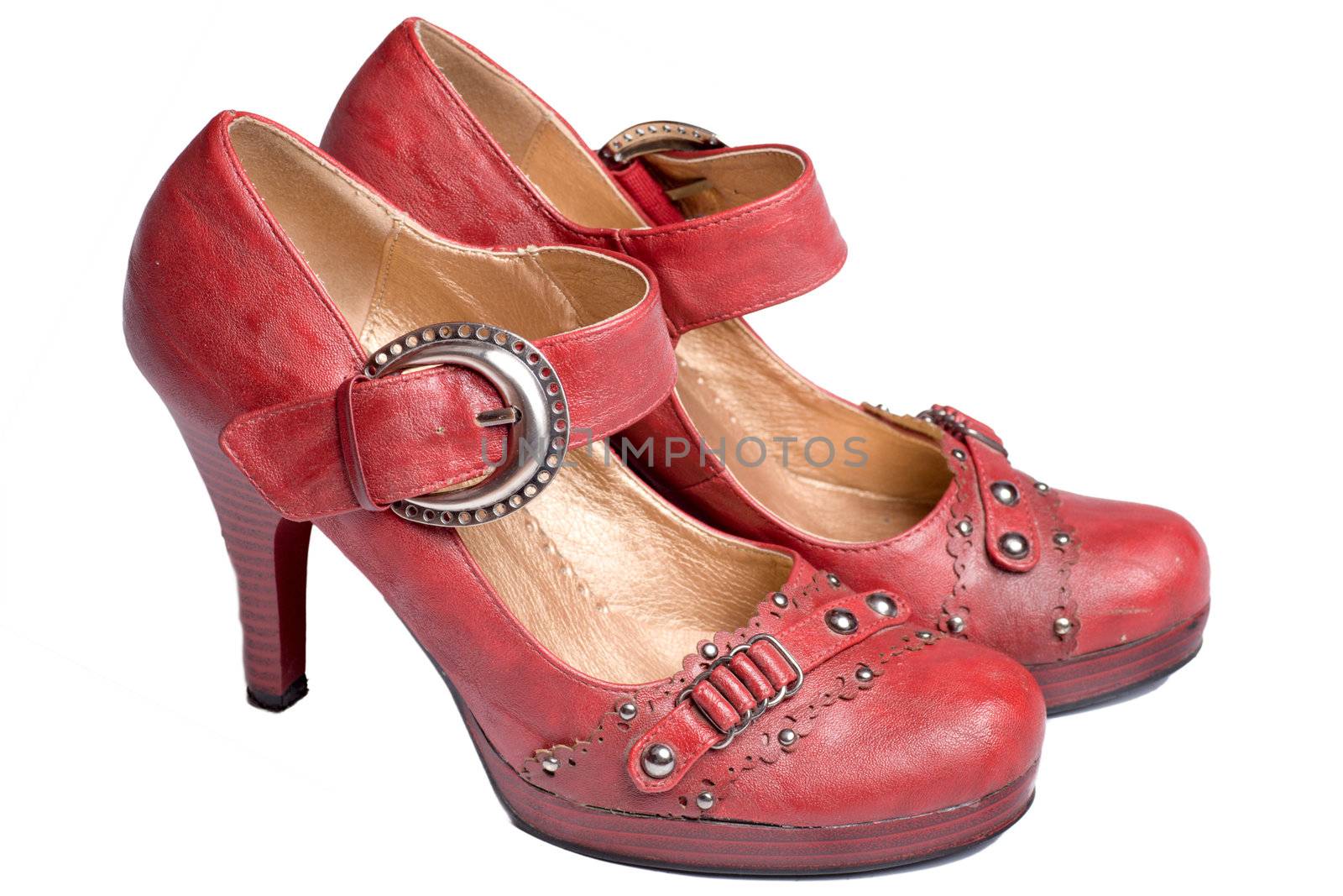 Red beautiful modern shoes with rivets isolated on white