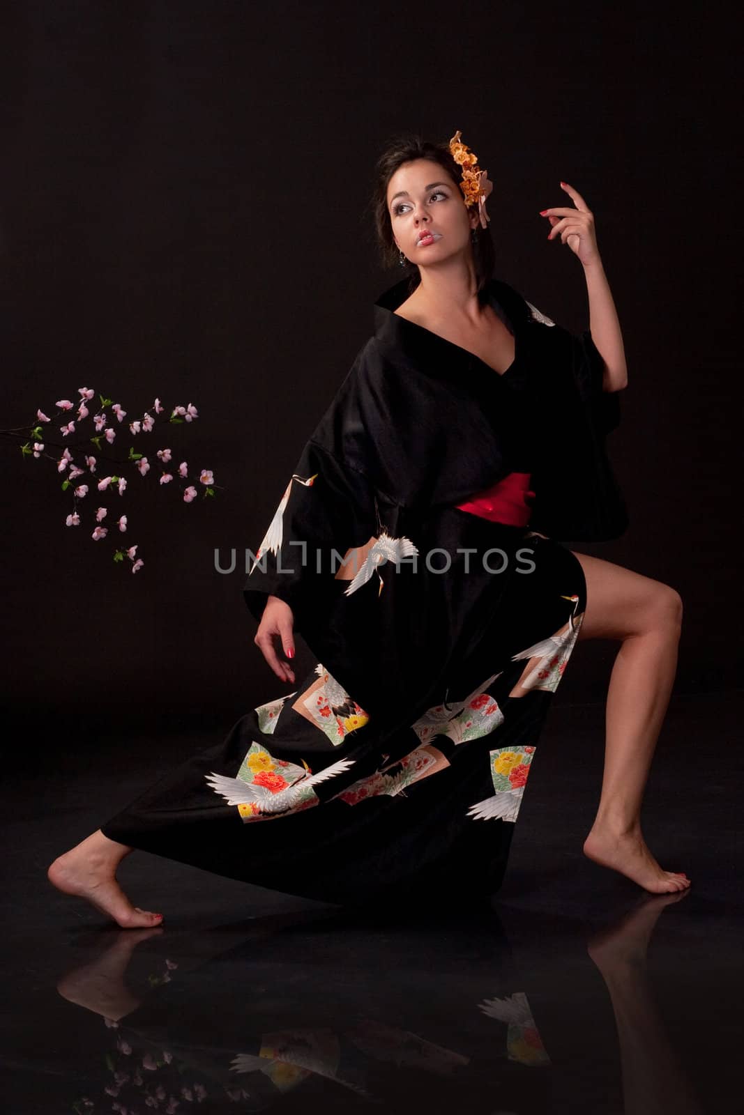 Japanese girl in traditional clothes posing to the camera