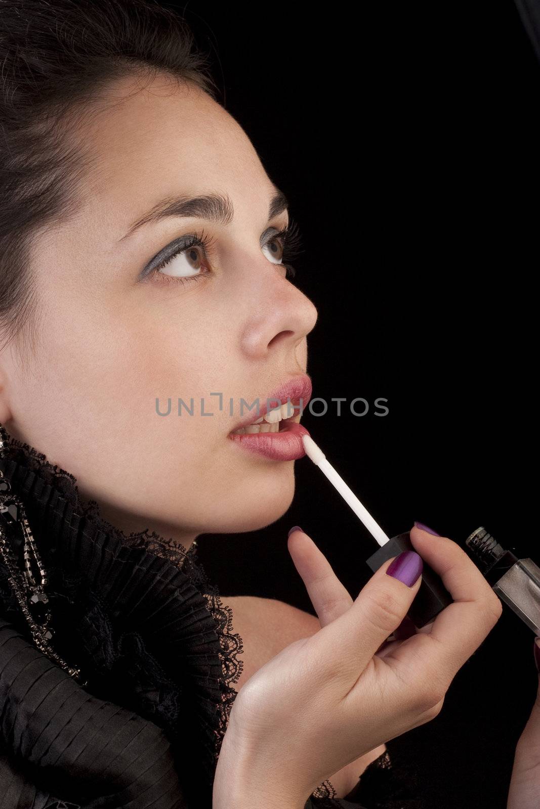 Girl is doing makeup and pose to the camera