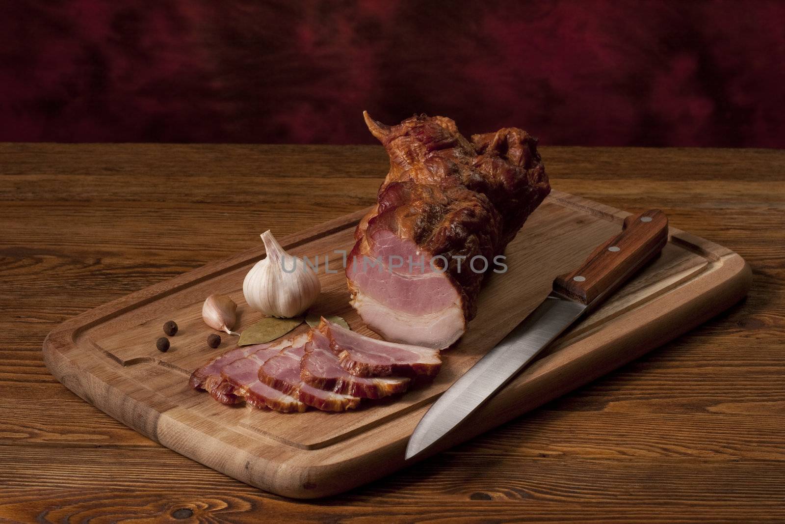 Composition with smoked ham on the table