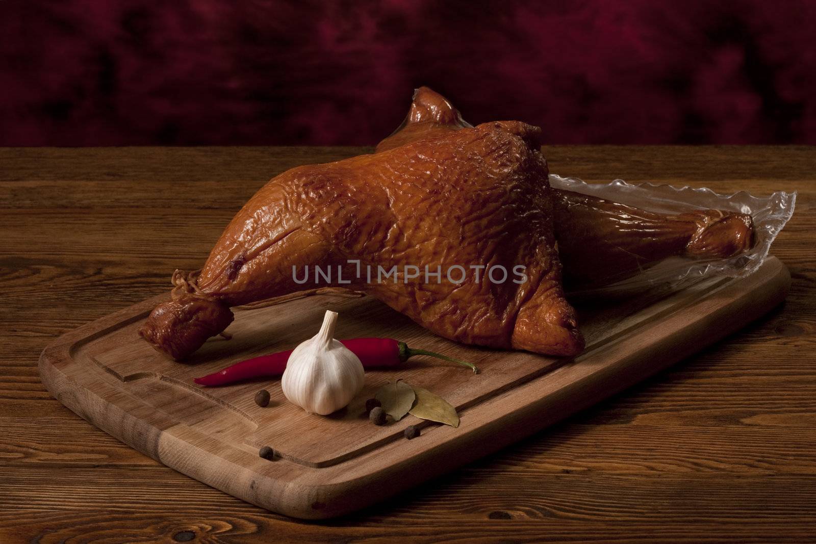 Composition with smoked chicken thighs on the table