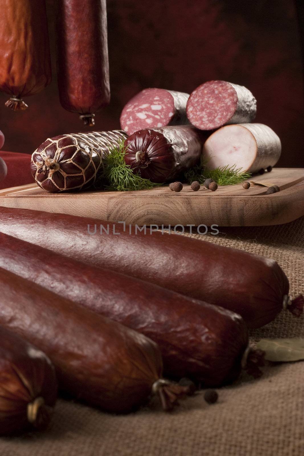 A composition of different sorts of sausages on dark background