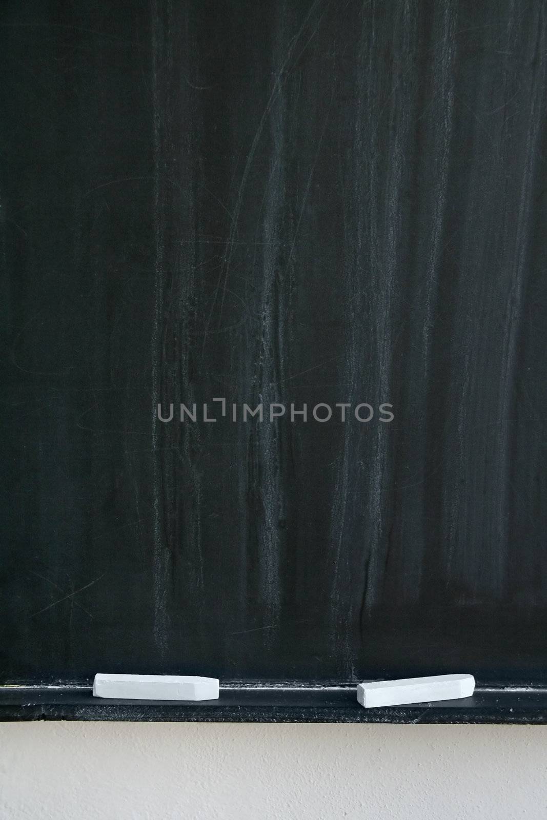 blackboard with two white chalks, detail photo