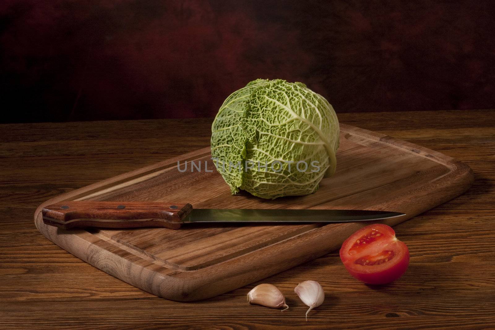 Green cabbage on wooden tablet