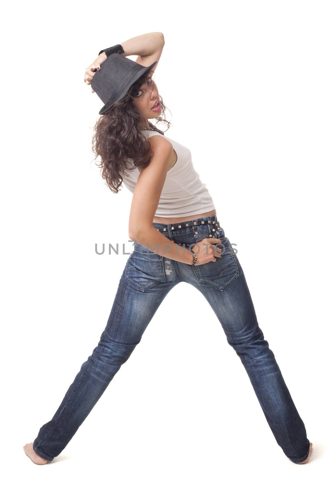 Young brunette girl is posing from back and touching a hat