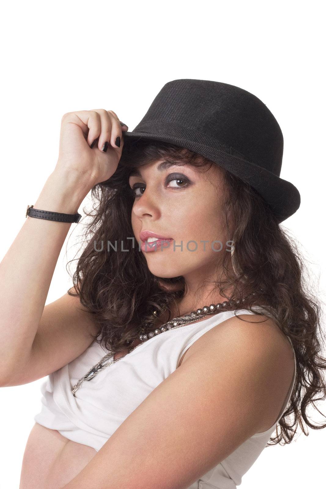 young brunette girl make pose for camera and touch her hat