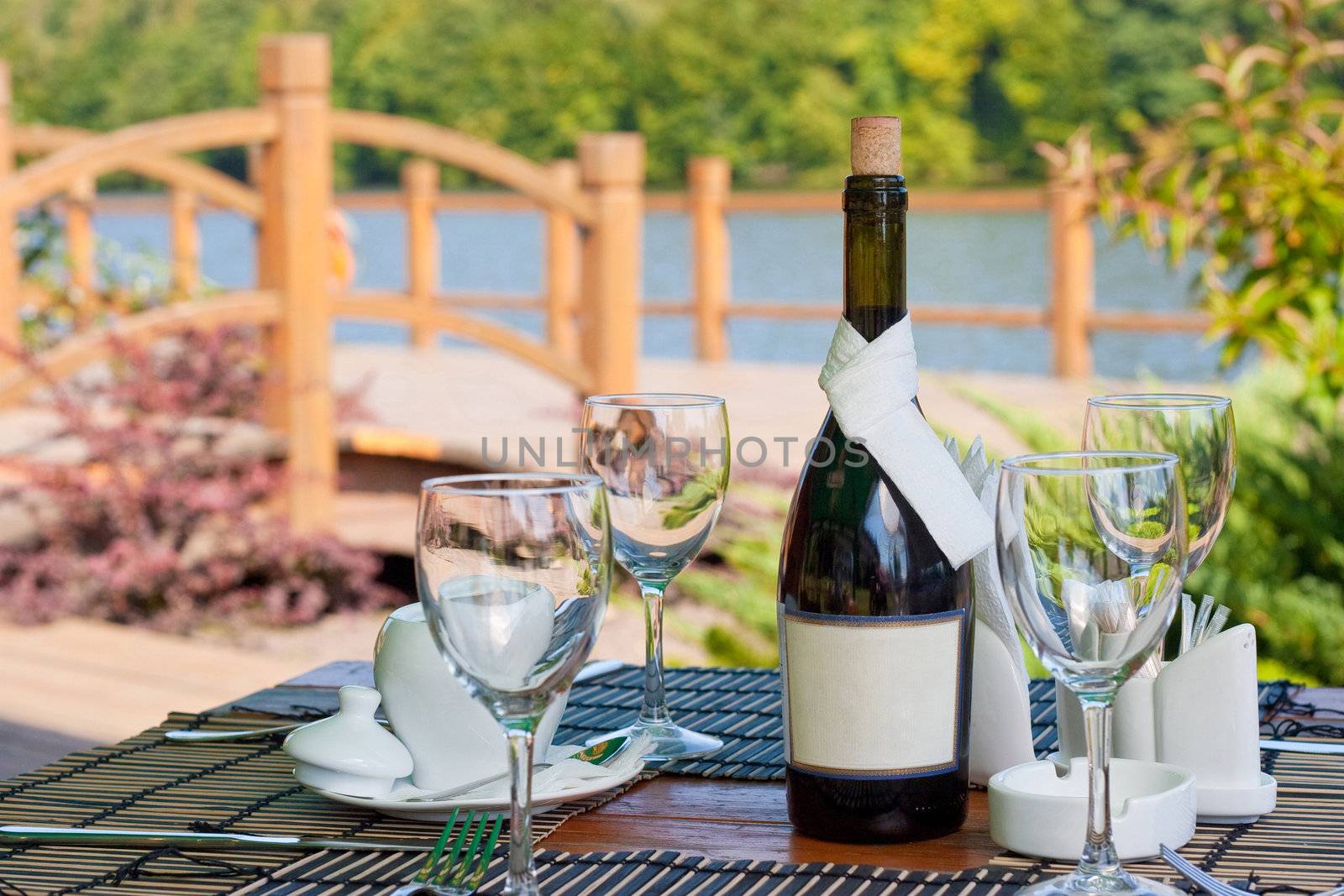 Beautiful served table in front of picturesque lake