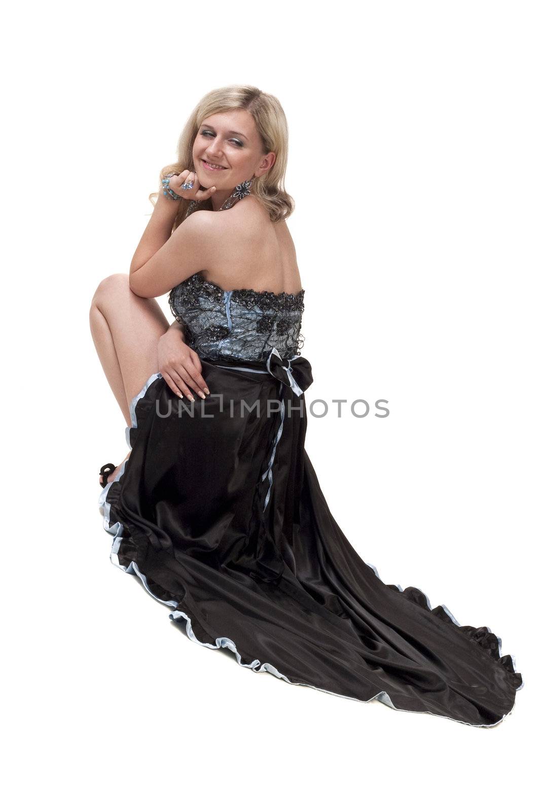 Beautiful young woman in elegant dress posing to the camera