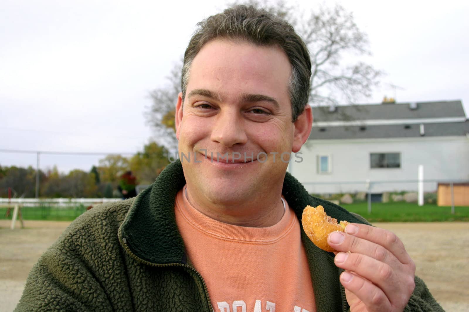 This is a picture of a man eating a donut.