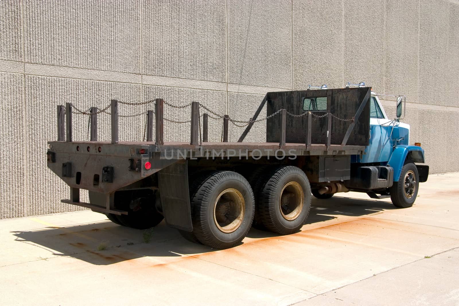 This is the rear view of a large flat bed stright truck.