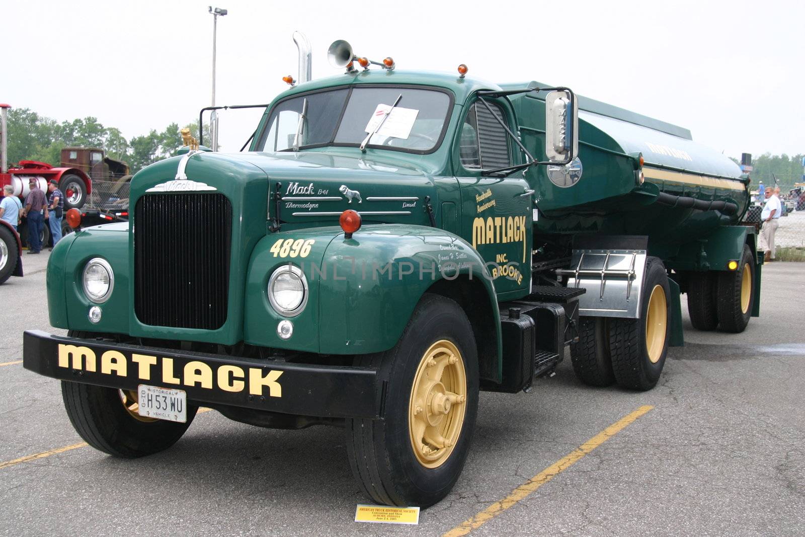 This is a dark green front view of a Matlack fuel tanker truck and trailer.