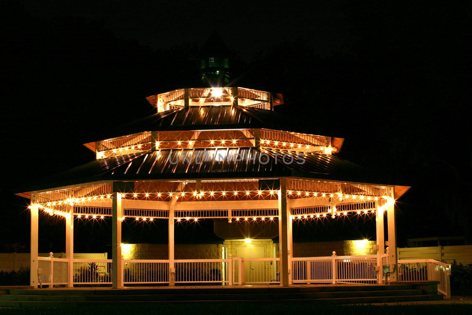 This is a photograph of the well lit and empty gazebo in downtown Safety Harbor, Florida shot at night.