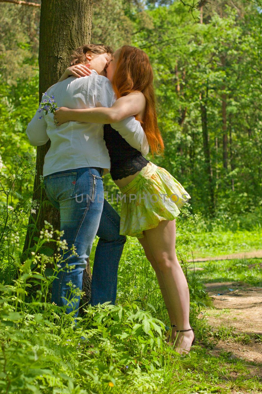 Two Girlfriends kissing in summer forest vacations