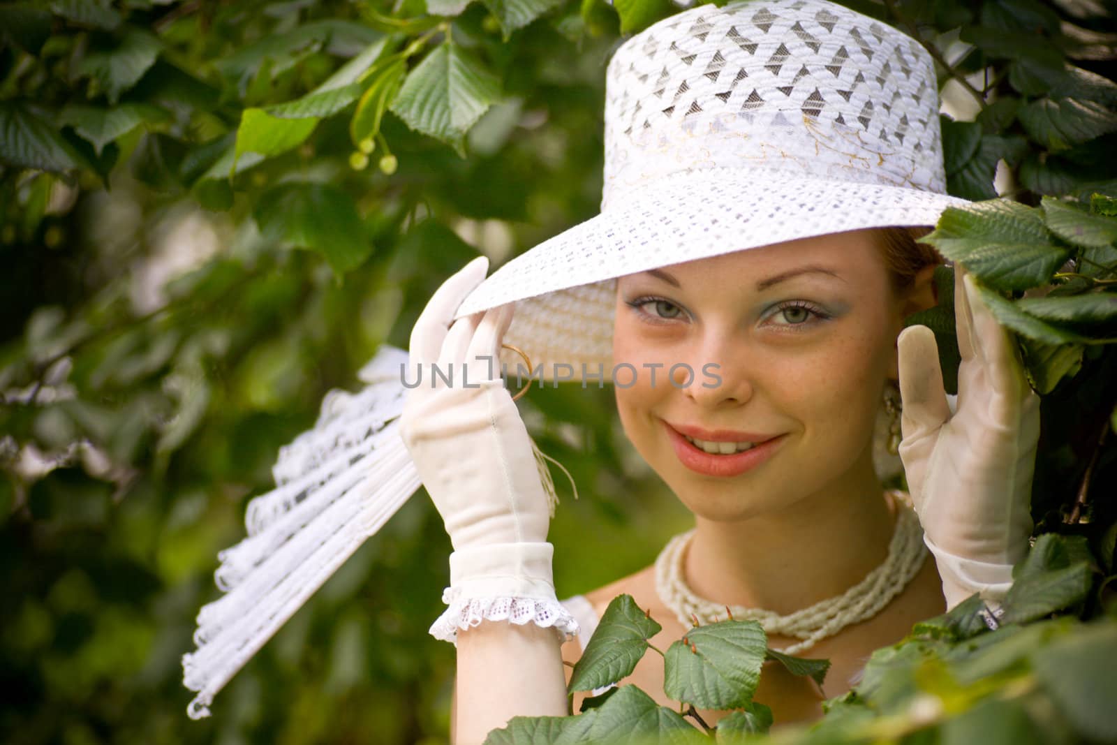 Young lady wearing white hat posing in leaf