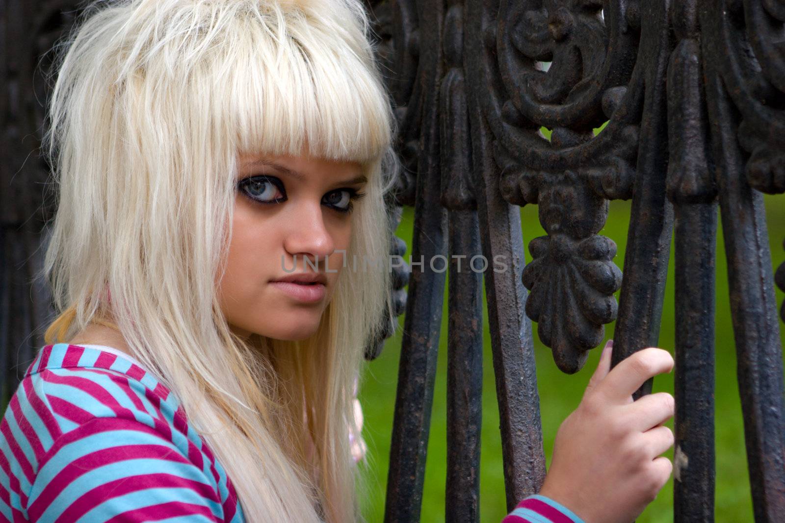 Funky young woman standing near the grating looking at you