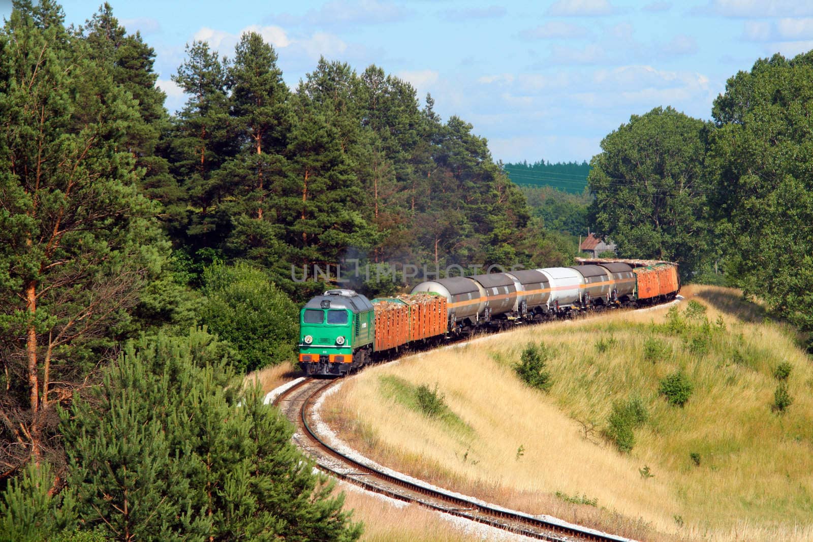 Freight train hauled by the diesel locomotive is passing its route