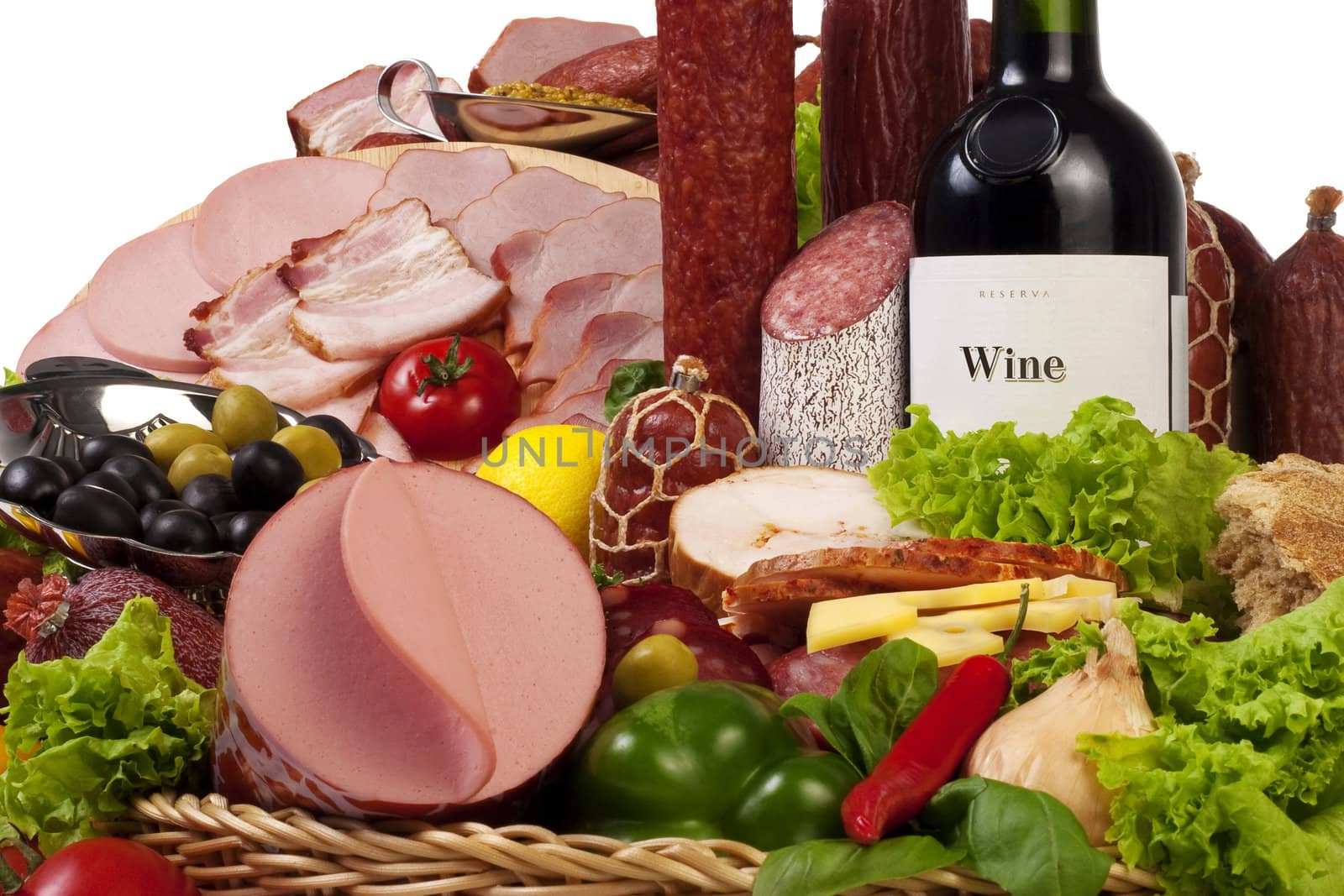 A composition of meat and vegetables with a bottle of wine isolated on white