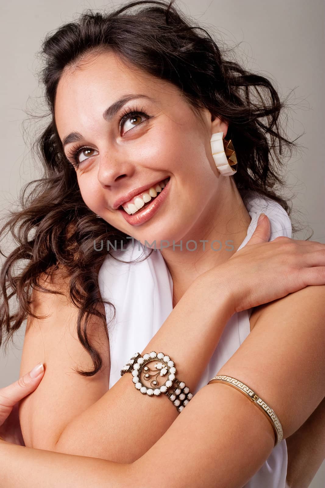 Cute young lady embracing her shoulders and laughing