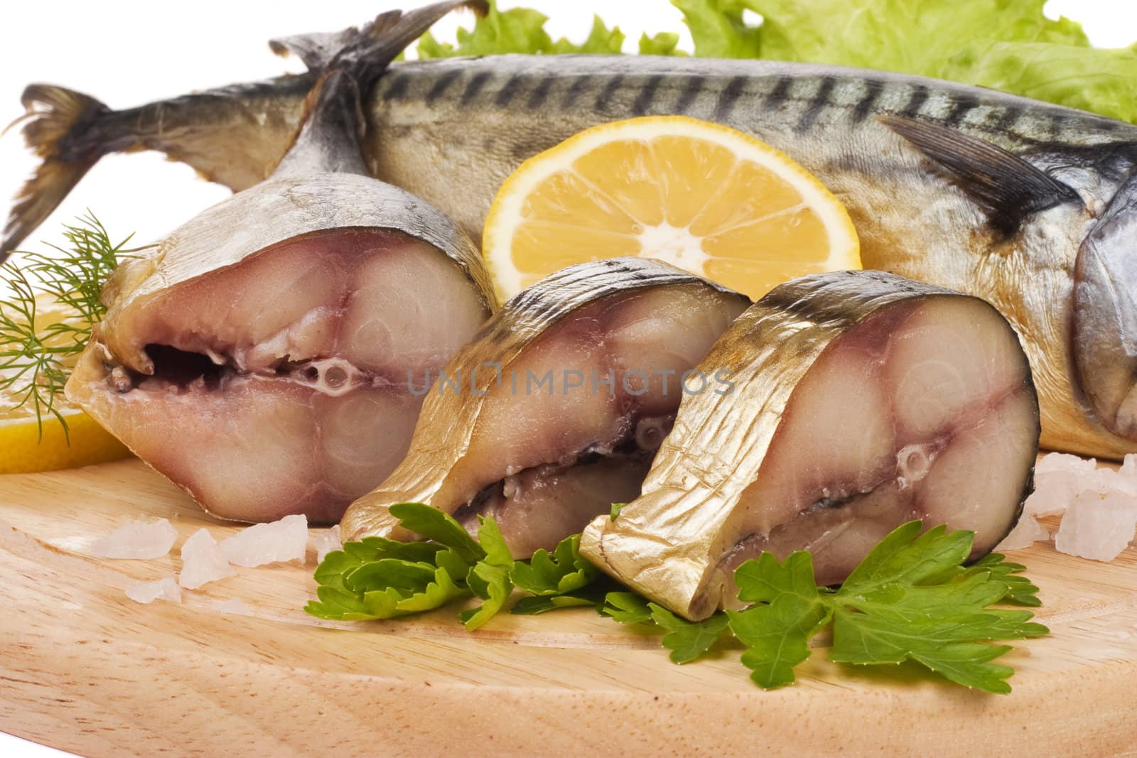 A composition with mackerel fish on wooden plate isolated on white