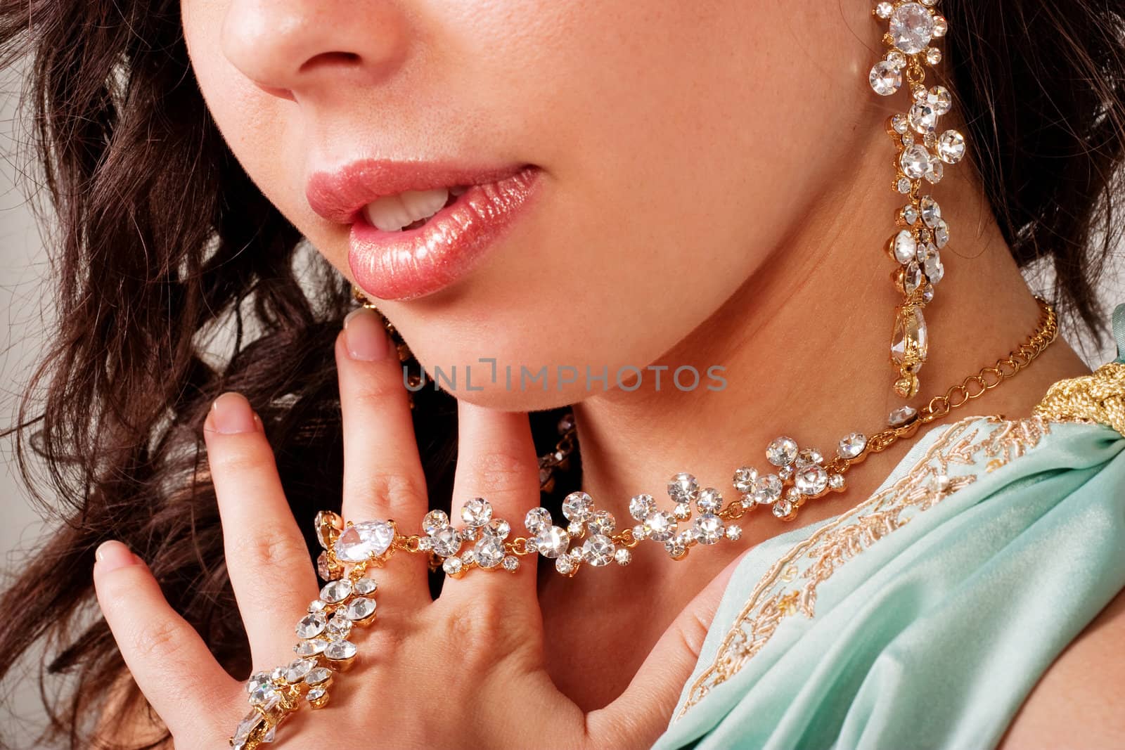 Beautiful young lady shows necklace and earring