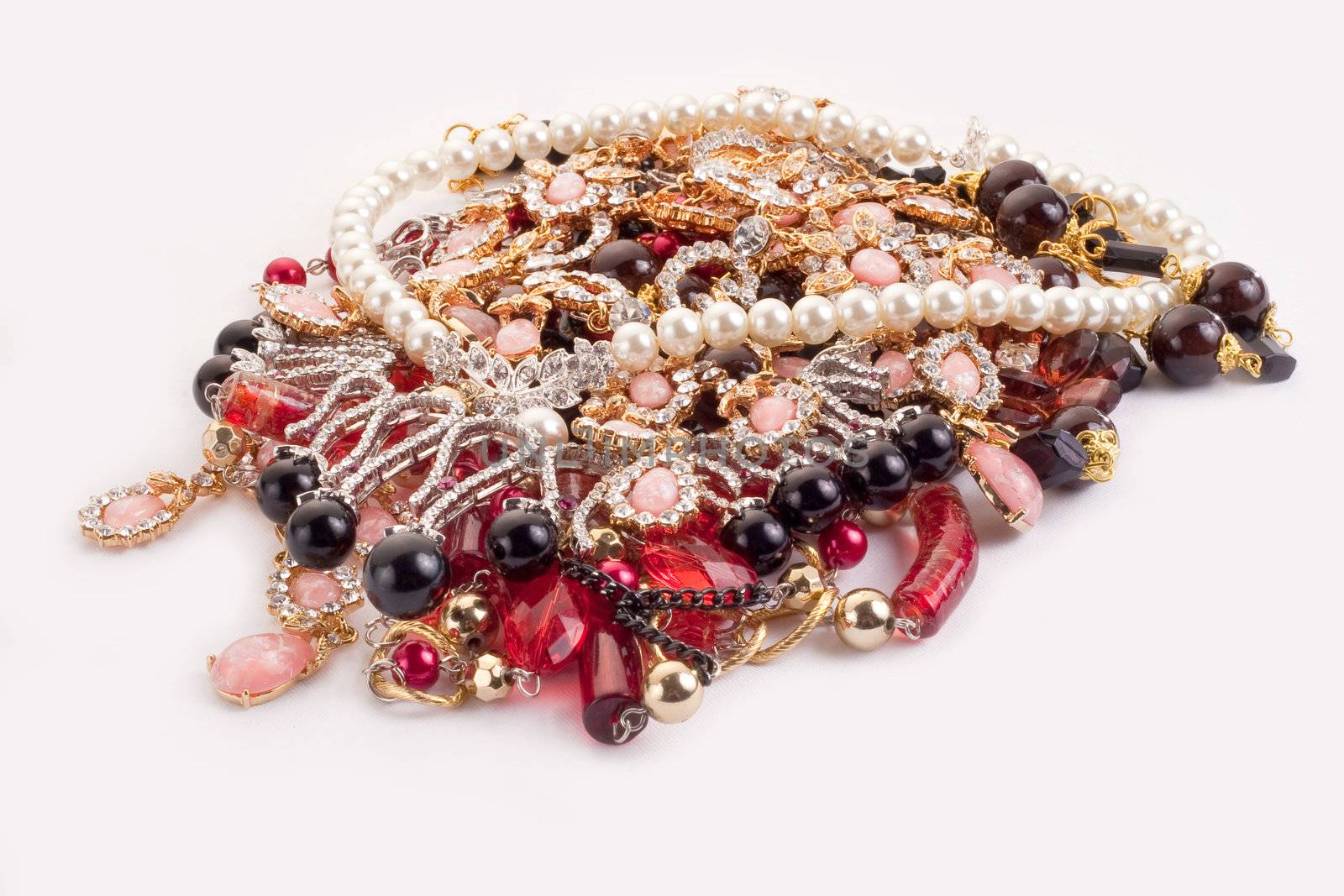 A pile of colored jewellery on white background by igor_stramyk
