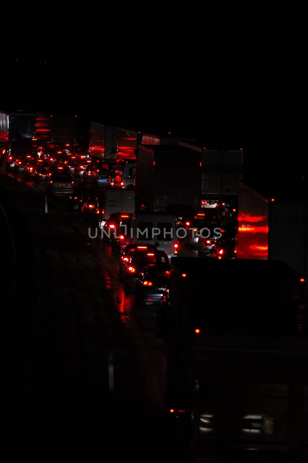 Heavy traffic. Many cars and trucks are waiting in a long line