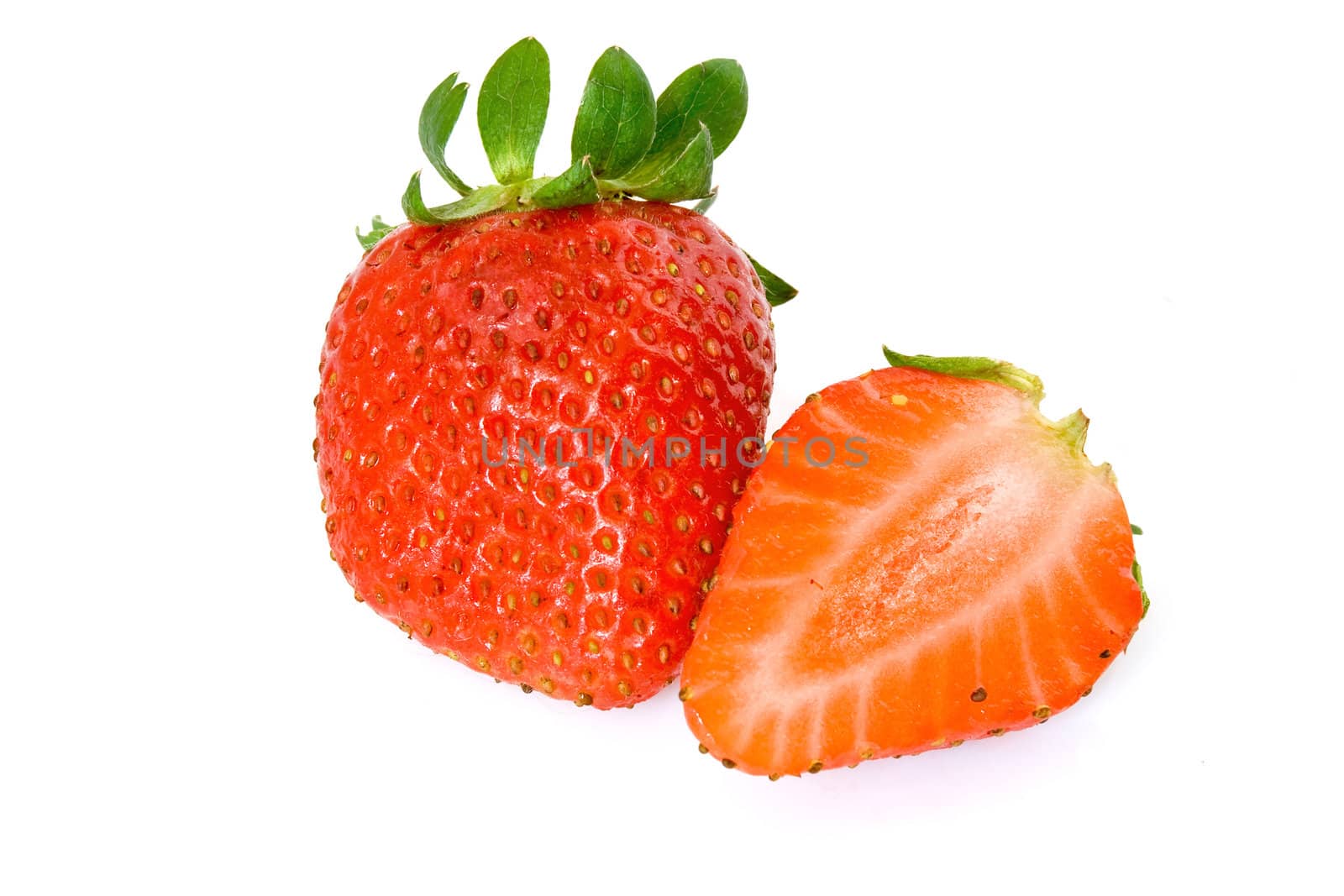 two strawberries, one cut in half, isolated on white background with clipping path