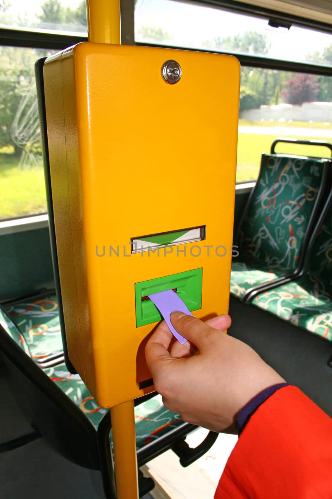 Woman is validating the ticket in the bus ticket validator