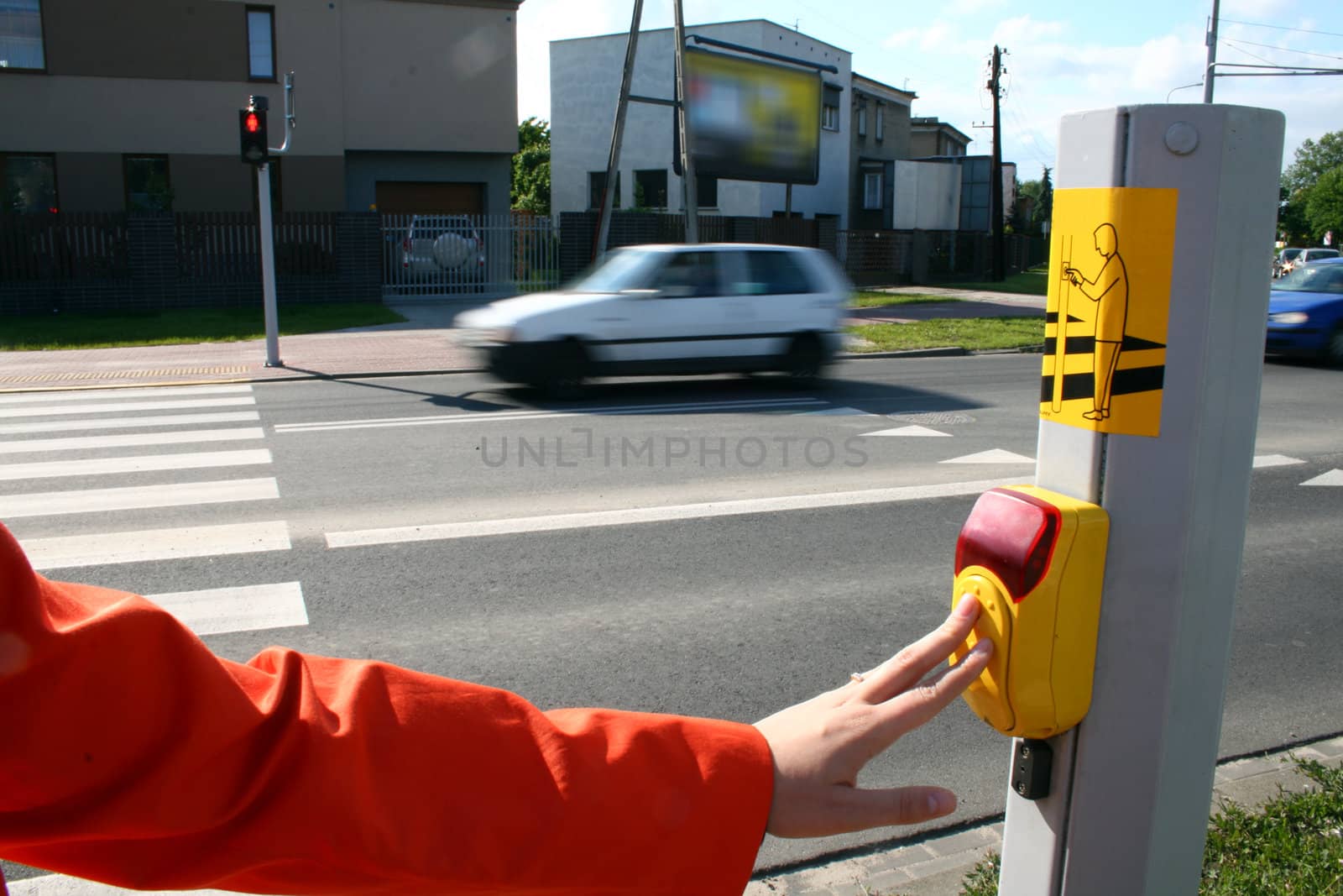 Woman pressing the button on the pedestrian crossing