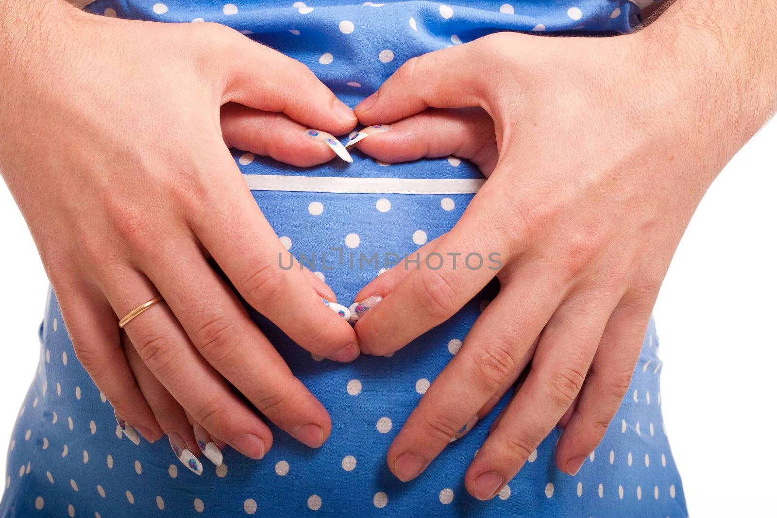 Two pairs of hands embracing belly tender.