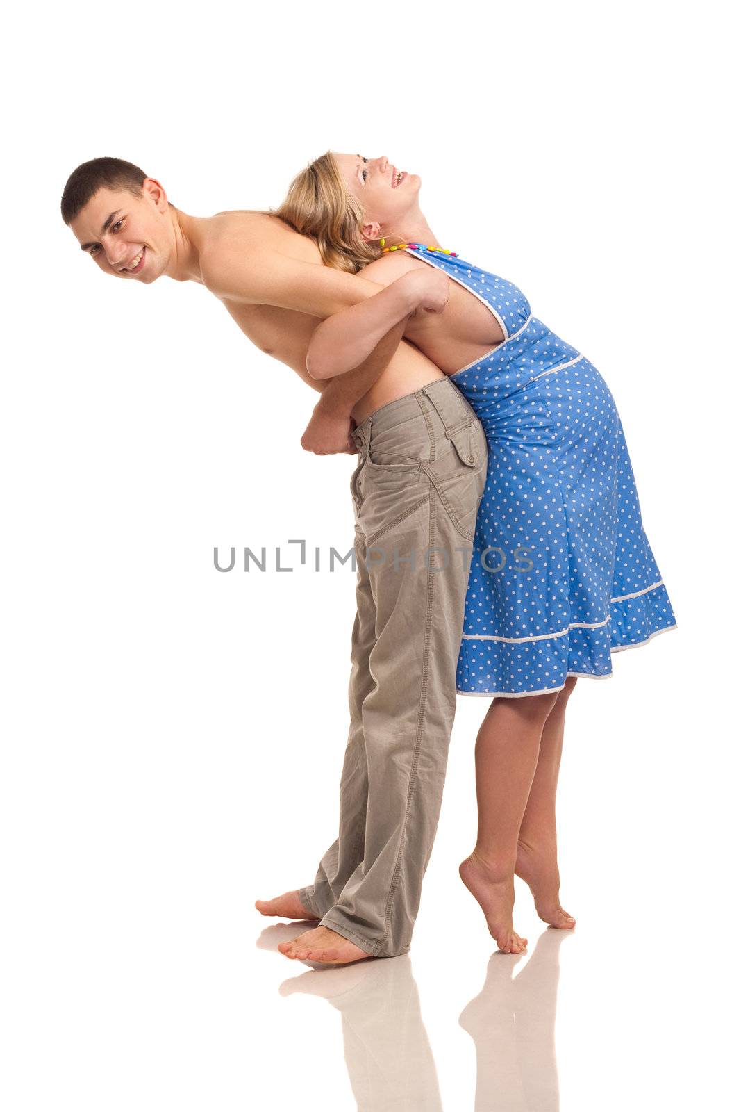 Pregnant woman with her husband doing exercises. Studio shoot on white.