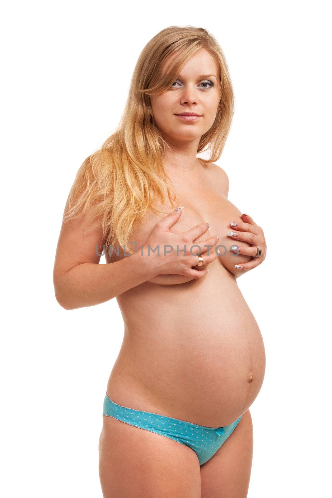 Beautiful pregnant woman standing. Closeup. Studio shoot on white