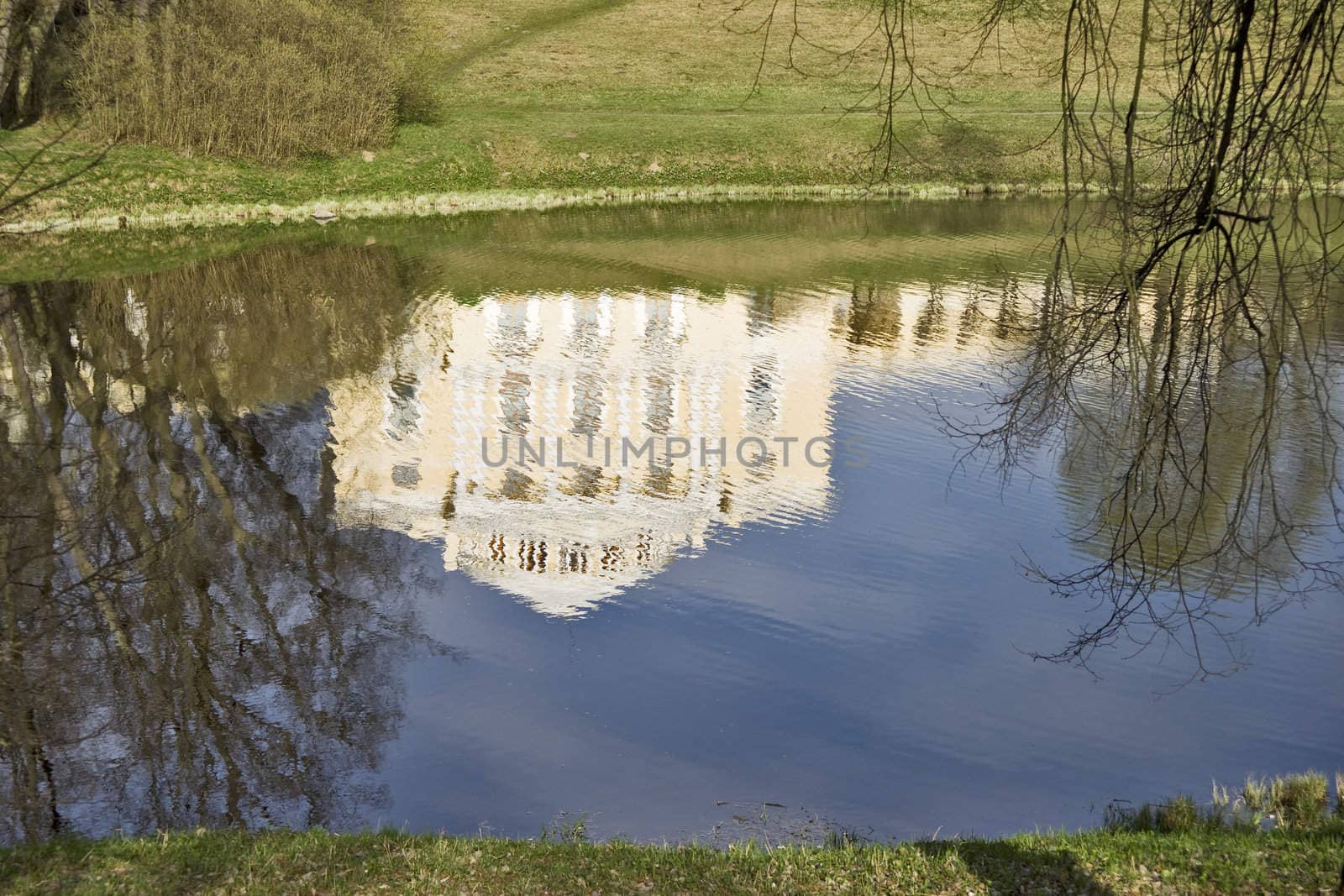 Palace and blue sky reflection in river water