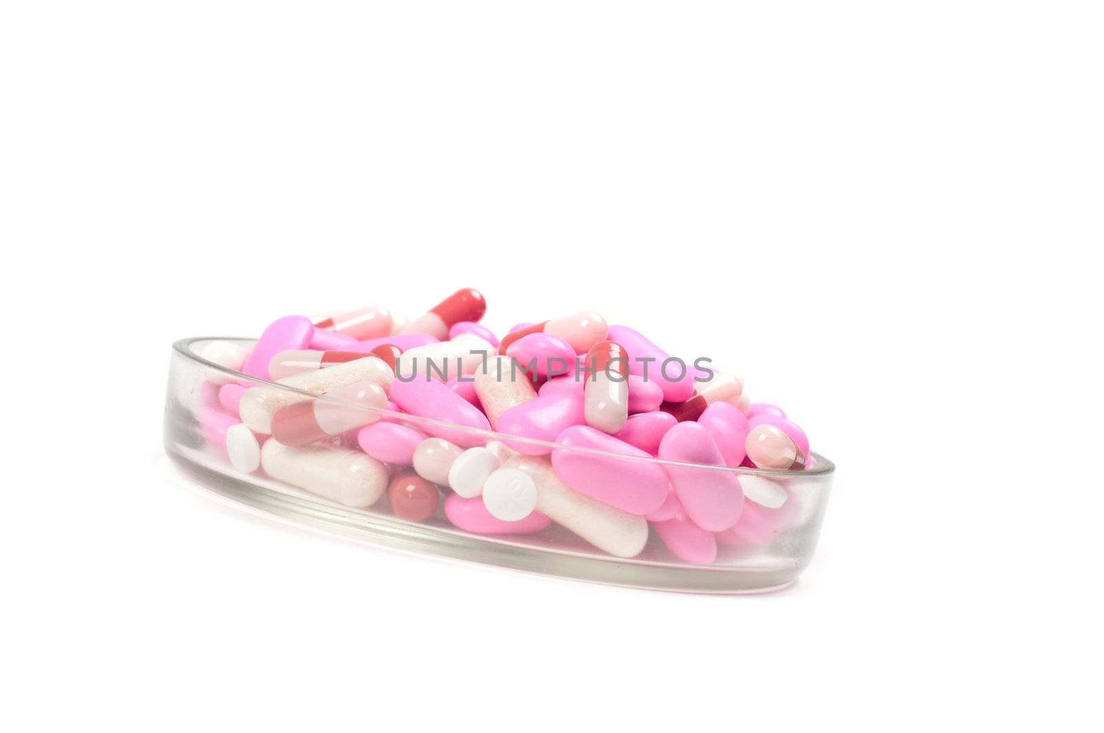 Shot of pink drugs (tablets) isolated on white
