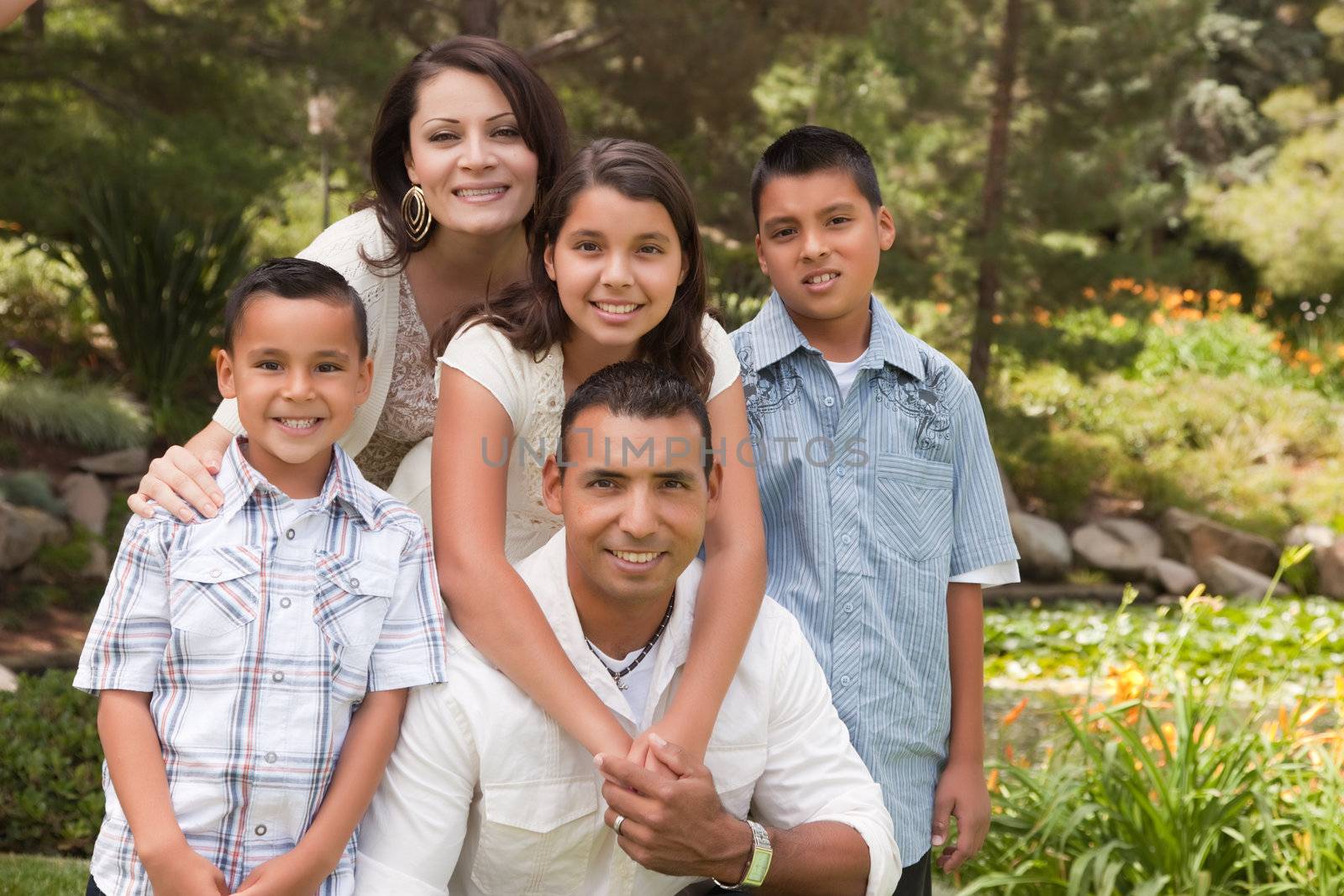 Happy Hispanic Family In the Park by Feverpitched