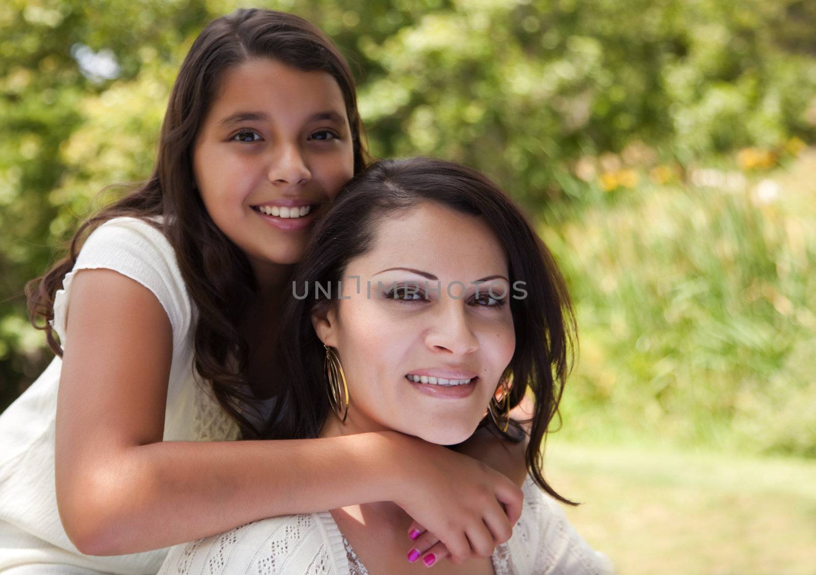 Happy Hispanic Mother and Daughter in the Park.