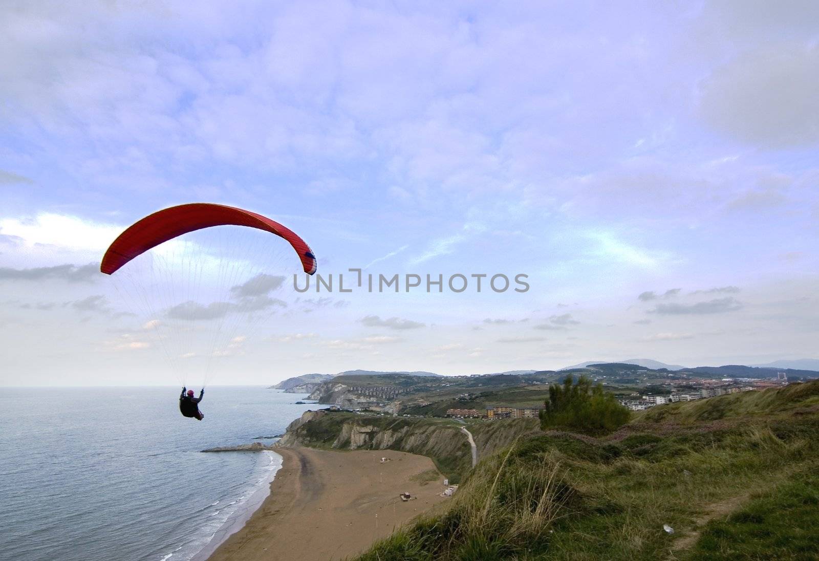 people having fun flying in the sky with parachute