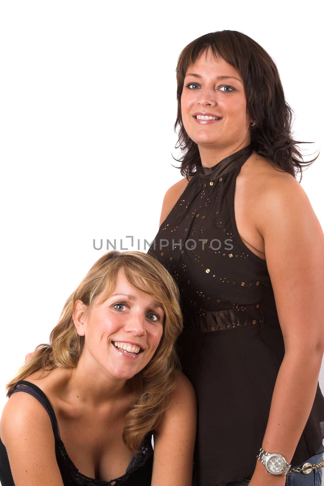 Two pretty sisters posing together on white background