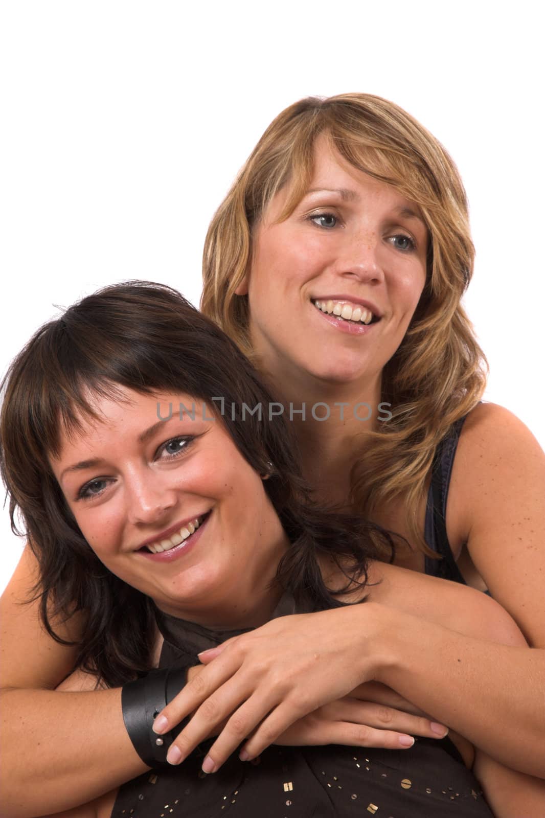 Two sisters posing on white background laughing