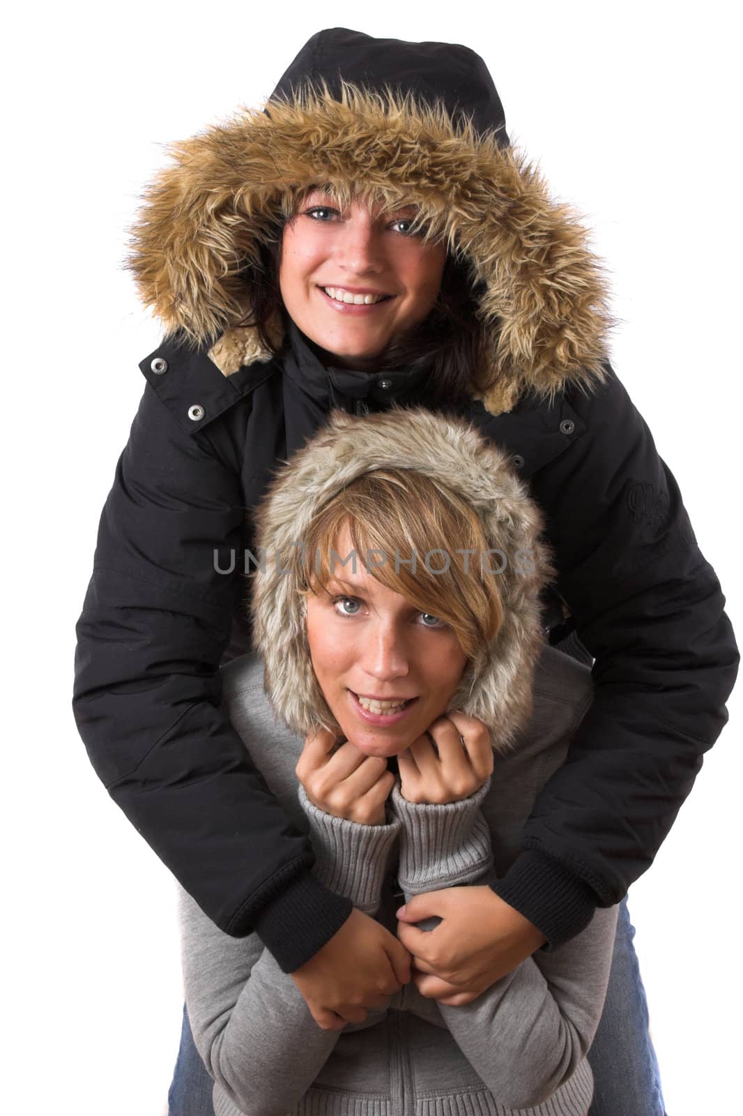 Two sisters hugging each other wearing winter clothing
