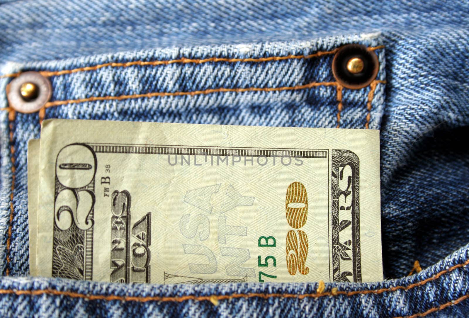 A twenty dollar bill sticking out the pocket of a pair of jeans.
