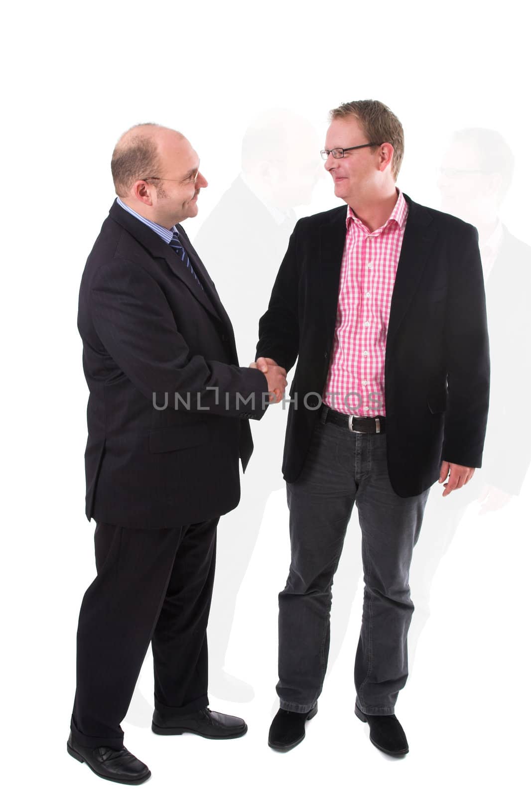 Two businessman having just come to an agreement and shaking eachother's hand on the deal