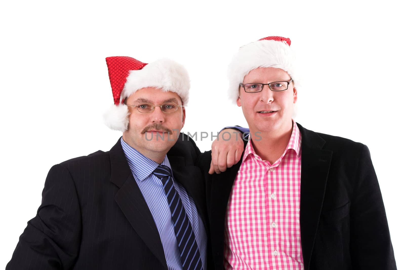 Two businessman standing next to each other wearing christmas hats