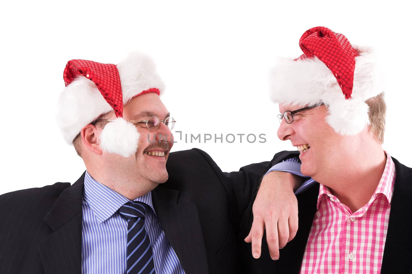 Two businessman wearing a santa hat having fun together
