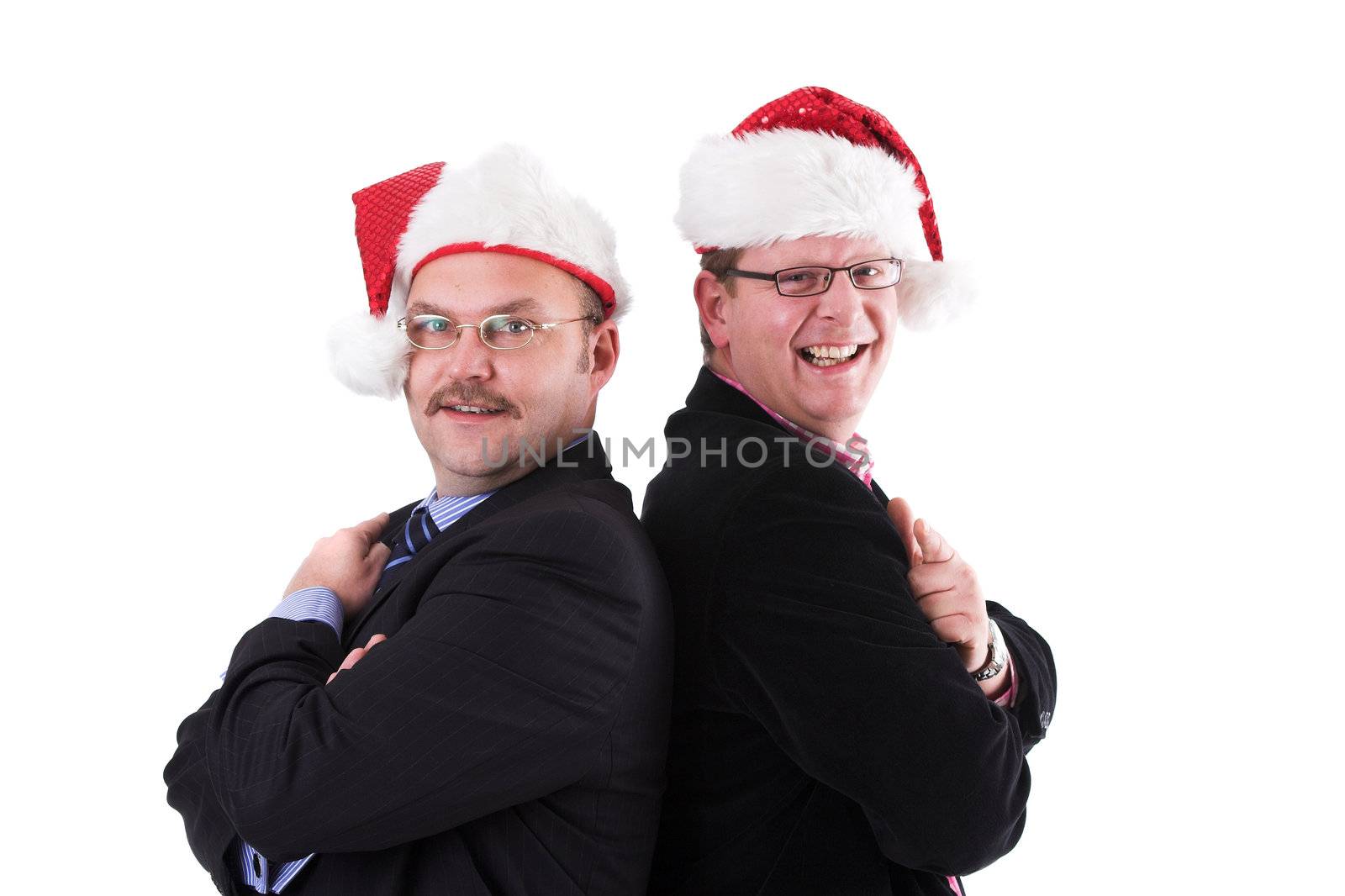 Two businessman standing with their back's to eachother wearing a christmas hat